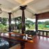 Achayans Homestay Mararikulam in Alappuzha: covered terrace with carved wooden table and garden view