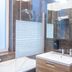 Wellness Apart Hotel Brussels bathroom with shower-tub combo, sink, mirror and wall-mounted hair dryer