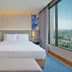 Hilton Garden Inn Bangkok Riverside room with king bed and large window overlooking Bangkok