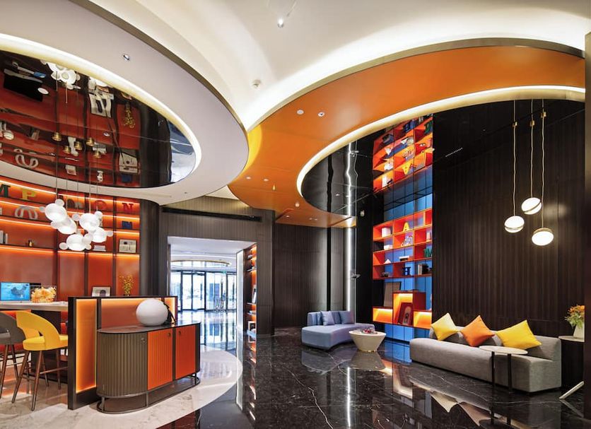 Hampton By Hilton Beijing Wangjing lobby with colorful seating and curved ceiling in Beijing