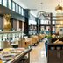 Leonardo Hotel Madrid City Center breakfast buffet with dining tables and modern lounge seating in Madrid