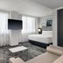DoubleTree by Hilton Long Island City New York room with wall-mounted TV, bed, sofa and city windows in Queens
