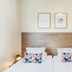 Appart'City Classic Thonon Les Bains room with twin bed and geometric pillows