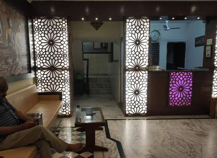 Hotel Ajay International, Agra lobby with lit patterned panels, reception desk, and seating area