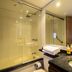 Travelers Obelisco Apartamentos bathroom in Bogotá with glass shower enclosure, sink and mirror