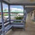 Scottish Inns Mcminnville exterior walkway with covered corridor, bench seating, and parking view