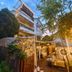 Tonight Inn in Hangzhou with a lit outdoor courtyard and multi-story facade at dusk