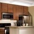 Oakwood Falls Church kitchen with wood cabinets, stainless steel appliances, and breakfast bar