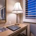 Grand Vista Hotel Simi Valley desk with lamp, mirror, chair and window with shutters