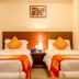 OYO 1594 Hotel Landmark in Visakhapatnam twin bed guest room with orange accents