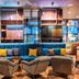 Nyx Hotel Munich By Leonardo Hotels lobby lounge with teal sofa and armchairs in Munich
