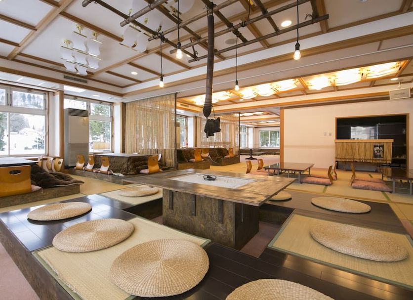 Rosenheim Hakuba in Hakuba, tatami-style lounge with low tables, floor seating, and hanging lights