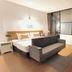 The Yak Cozy Chiang Mai room with bed, sofa and city-view window in Chiang Mai