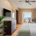 Bahia Del Duque room in Adeje with king bed, balcony ocean view, TV and seating area