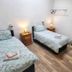 Deepcut Lodge Bed & Breakfast Self Service in Camberley: twin guest room with bedside lamps and wooden furniture