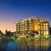 New Century Grand Hotel Kaifeng in Kaifeng at sunset beside a reflective lake