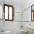 Vettonia Ávila bathroom with double sink, large mirror, toilet, bidet and window