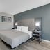 Quality Inn Laurinburg guest room with a king bed, desk, and adjoining bathroom doorway