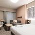 Richmond Hotel Obihiro Ekimae room with two beds, desk, chair and window curtains in Obihiro