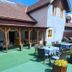 Pension Göschlberger in Mondsee with a covered patio, outdoor dining tables, and green turf seating area