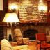 Austral Bahia Blanca Hotel lounge with stone fireplace, armchairs and warm ambient lighting in Bahía Blanca