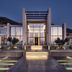 The Royal Senses Resort & Spa Crete, Curio Collection by Hilton in Panormos, lit modern resort entrance at dusk