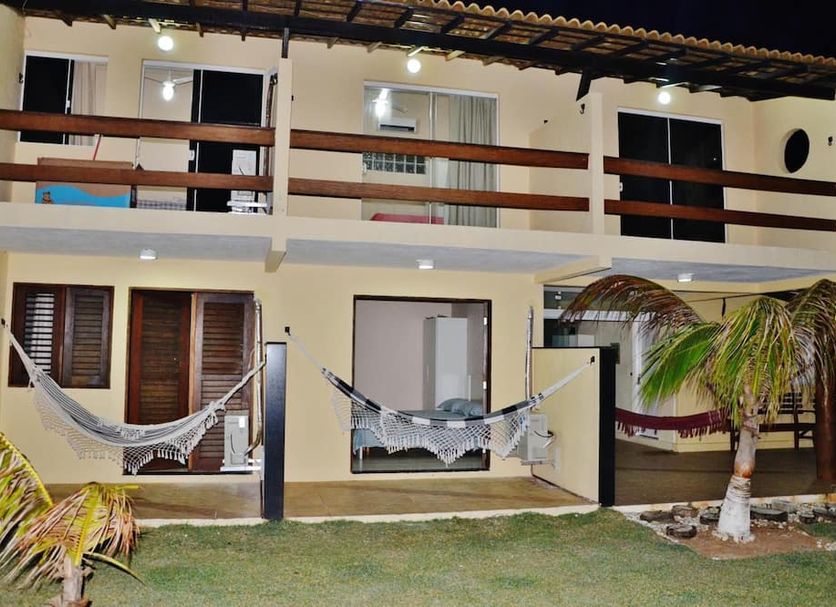 Pousada Aldeia do Forte in Porto de Sauipe, two-story inn with hammocks and palm trees