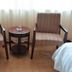 Qilu International Hotel Harbin room with two armchairs and small round table by window