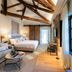 Sofraga Palacio, Ávila suite with exposed beams, king bed, sofa and large window
