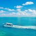 Kagi Maldives Resort & Spa in Kagi with a speedboat on clear turquoise ocean under a blue sky