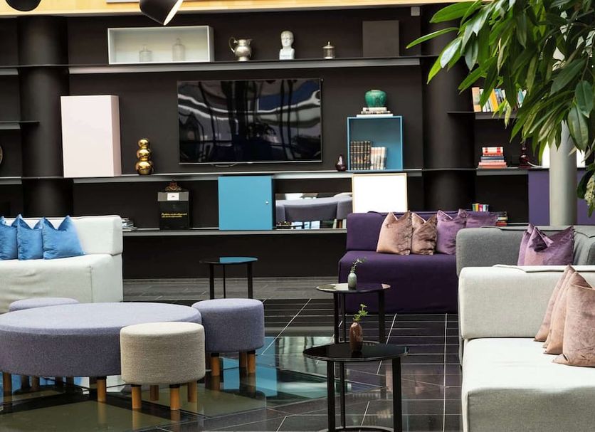 Radisson Blu Airport Terminal Hotel Stockholm lounge with sofas, ottomans, and wall-mounted TV in Arlanda