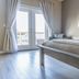Hotel Whiskey in Pascagoula guest room with king bed, balcony doors, and natural light