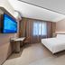 Hanting Hotel Shenyang Santaizi Metro Station room with bed, desk, TV and window in Shenyang
