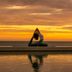 Azerai Ke Ga Bay in Phan Thiet: guest doing yoga by an infinity pool at sunset with ocean view