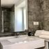 Auberge La Fontaine Aux Bretons in Pornic, modern bathroom with double sink, tiled shower and towels