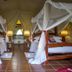 Mbuzi Mawe Serena Camp Serengeti twin safari tents with canopy beds and bedside lamps