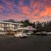Red Roof Inn Baltimore South - Glen Burnie exterior at sunset with parking lot and vivid pink sky