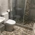 The Peel Aldergate Tamworth bathroom with glass shower, toilet and mosaic tile floor
