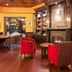 Best Western Plus Cobourg Inn & Convention Centre library lounge with fireplace, bookshelves and red chairs