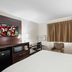 Red Roof Inn Bristol guest room with TV, desk, mini fridge, microwave and window air conditioner