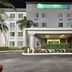 La Quinta Inn & Suites by Wyndham Sawgrass in Sunrise, exterior entrance with palm trees