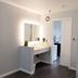 Capri Suites Anaheim interior vanity with mirror, sink and doorway in Anaheim