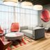 Residence Inn by Marriott Montreal Airport lobby seating area with sofas, chairs, and wall-mounted TV in Montreal