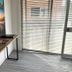 The Oaks Hotel Motel Wollongong room with desk, wall art and sliding glass door with blinds