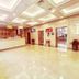 Long Ge Hotel Beijing lobby with front desk, polished tile floor, seating area and bright ceiling lights