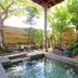 Hotel Matsukaze, Toyota: outdoor garden hot spring bath with trees, rocks and bamboo fence