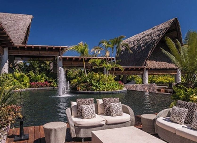 Mayan Palace Puerto Vallarta pool with fountain, tropical landscaping and lounge seating in Puerto Vallarta