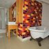 Bathroom at The Brudenell Aldeburgh in Ipswich with freestanding tub, shower and tiled vanity area