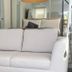 Mar Del Norte in San Juan: white sofa in a guest room with wall-mounted TV and mirror