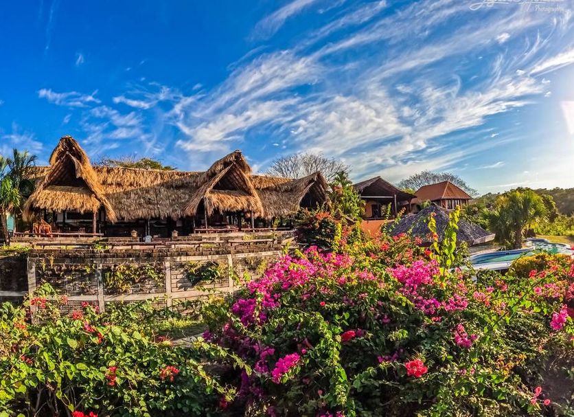 Hacienda Puerta del Cielo Eco Lodge & Spa in Masaya with lush gardens, thatched huts, and sky views